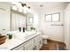 This bathroom has a large mirror over a single vanity and toilet with neutral color scheme at 15217 N 60Th St, Scottsdale, AZ 85254