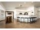 Spacious kitchen features a breakfast bar with seating, white cabinetry, and a view of the adjacent living area at 15217 N 60Th St, Scottsdale, AZ 85254