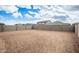 Unfinished backyard with block wall fencing and neighboring homes visible at 18433 W Monte Lindo Ln, Surprise, AZ 85387