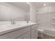 Well-lit bathroom featuring double sinks, white cabinetry, and a shower-tub combination at 18433 W Monte Lindo Ln, Surprise, AZ 85387