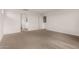 A large, carpeted bedroom with neutral walls, adjacent to a bathroom and a closet at 18433 W Monte Lindo Ln, Surprise, AZ 85387