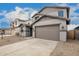 The two-story home boasts a two car garage and low maintenance desert landscaping at 18433 W Monte Lindo Ln, Surprise, AZ 85387