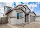 The two-story home boasts a neutral color scheme and low maintenance desert landscaping at 18433 W Monte Lindo Ln, Surprise, AZ 85387