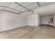 Spacious, unfinished two-car garage with concrete floor and a door to the house at 18433 W Monte Lindo Ln, Surprise, AZ 85387