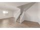 Large living area featuring wood look tile floor and a staircase at 18433 W Monte Lindo Ln, Surprise, AZ 85387