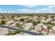 Aerial view of a suburban neighborhood with houses, green spaces, and a clear blue sky at 2032 E Sierra Madre Ave, Gilbert, AZ 85296