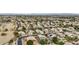 Wide aerial view of a well-established community featuring diverse homes and mature trees, with mountains in the background at 2032 E Sierra Madre Ave, Gilbert, AZ 85296