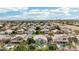 Scenic aerial shot of a residential neighborhood with numerous homes, palm trees and mountain views at 2032 E Sierra Madre Ave, Gilbert, AZ 85296
