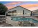 Spacious backyard with pool, rock waterfall feature, hot tub, and outdoor seating at 2032 E Sierra Madre Ave, Gilbert, AZ 85296