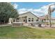 Resort-style backyard with a pool, hot tub, palm trees, and well-manicured lawn at 2032 E Sierra Madre Ave, Gilbert, AZ 85296