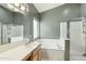 Bathroom featuring a combination shower/tub, with tile floors, window and bright lighting at 2032 E Sierra Madre Ave, Gilbert, AZ 85296