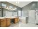 A large bathroom features a combination shower/tub, with tile floors and bright lighting at 2032 E Sierra Madre Ave, Gilbert, AZ 85296