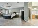 A bedroom with an adjacent bathroom featuring herringbone floors and bright neutral walls at 2032 E Sierra Madre Ave, Gilbert, AZ 85296