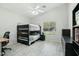 Bright bedroom with a wooden bunk bed, tiled floor, and natural light from the window at 2032 E Sierra Madre Ave, Gilbert, AZ 85296