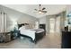 Spacious bedroom featuring a ceiling fan, herringbone floors, and ample natural light at 2032 E Sierra Madre Ave, Gilbert, AZ 85296