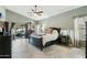 A spacious bedroom with access to the outdoor patio featuring a ceiling fan and ample natural light at 2032 E Sierra Madre Ave, Gilbert, AZ 85296