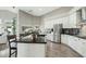 Kitchen featuring stainless steel refrigerator, white cabinets, dark counters and a center island at 2032 E Sierra Madre Ave, Gilbert, AZ 85296