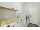 Clean laundry room features a wooden countertop with lots of storage space at 2032 E Sierra Madre Ave, Gilbert, AZ 85296