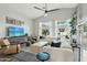 Bright and airy living room featuring a large sectional sofa, media cabinet, and multiple windows with natural light at 2032 E Sierra Madre Ave, Gilbert, AZ 85296