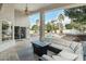 Covered outdoor patio with a seating area, ceiling fan, and views of the pool and yard at 2032 E Sierra Madre Ave, Gilbert, AZ 85296