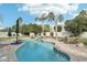 Inviting backyard pool area with lush landscaping and a relaxing waterfall feature at 2032 E Sierra Madre Ave, Gilbert, AZ 85296