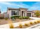 Charming home with stone accents, desert landscaping, a two-car garage, and a covered front porch at 20365 W Brittlewood Ave, Buckeye, AZ 85396