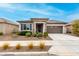 Charming single-story home featuring a well-manicured front yard and a neutral-colored exterior at 20365 W Brittlewood Ave, Buckeye, AZ 85396