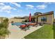 Relaxing backyard featuring a sparkling pool, lounge chairs, lush grass and covered patio at 2066 N Canelo Hls, Mesa, AZ 85207