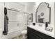 Well-lit bathroom featuring modern fixtures, sleek vanity, and a shower-tub combination at 2066 N Canelo Hls, Mesa, AZ 85207