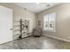 Bright bedroom featuring a stylish bookshelf, comfortable chair, and plantation shutters at 2066 N Canelo Hls, Mesa, AZ 85207