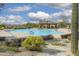 Large community pool with surrounding landscaping, shaded seating area and desert views at 2066 N Canelo Hls, Mesa, AZ 85207