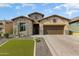 Charming stone-accented home with a well-manicured lawn and inviting desert landscape at 2066 N Canelo Hls, Mesa, AZ 85207