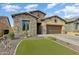 Charming stone-accented home with a well-manicured lawn and inviting desert landscape at 2066 N Canelo Hls, Mesa, AZ 85207