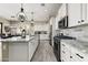 Modern kitchen featuring white cabinets, granite countertops, and stainless steel appliances at 2066 N Canelo Hls, Mesa, AZ 85207