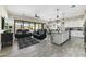 Open-concept living space with stylish furniture, a ceiling fan, and seamless access to the backyard at 2066 N Canelo Hls, Mesa, AZ 85207