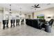 Open concept living space featuring a kitchen island with seating and a comfortable living area with a large TV at 2066 N Canelo Hls, Mesa, AZ 85207