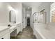 Spacious bathroom with double vanity, soaking tub, and a glass-enclosed shower at 2066 N Canelo Hls, Mesa, AZ 85207