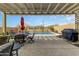 Inviting outdoor patio area with a pergola, dining set, and a view of the sparkling pool at 2066 N Canelo Hls, Mesa, AZ 85207