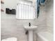 Charming bathroom with pedestal sink, white subway tile, and stylish blue curtains at 2218 N Dayton St, Phoenix, AZ 85006