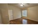 This is a neutral bedroom that features a ceiling fan and laminate wood floors at 23167 W Lasso Ln, Buckeye, AZ 85326