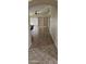 Inviting hallway with tiled flooring leads to a bright, open living area with vaulted ceilings and large windows at 23167 W Lasso Ln, Buckeye, AZ 85326