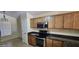 Functional kitchen showcasing wood cabinets, granite countertops, and stainless steel appliances at 23167 W Lasso Ln, Buckeye, AZ 85326