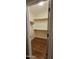 Walk-in closet with wood shelving and flooring at 23167 W Lasso Ln, Buckeye, AZ 85326