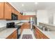 Well-lit kitchen featuring stainless steel appliances, granite countertops, and wooden cabinets at 24824 S Golfview Dr, Sun Lakes, AZ 85248