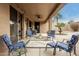 Spacious covered patio with stylish furniture and outdoor decor at 24824 S Golfview Dr, Sun Lakes, AZ 85248