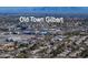 Scenic aerial view of Old Town Gilbert showcasing a vibrant cityscape with nearby residential area and distant mountain views at 26 S Tiago Dr, Gilbert, AZ 85233