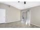 Bedroom with wood-look floors, neutral walls, ceiling fan, and a sliding glass door to the back yard at 26 S Tiago Dr, Gilbert, AZ 85233