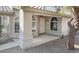 Charming front entrance with arched windows, rock landscaping, and neutral paint scheme at 26 S Tiago Dr, Gilbert, AZ 85233