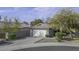 Charming single-story home with a two-car garage, a paved driveway and drought tolerant front yard at 26 S Tiago Dr, Gilbert, AZ 85233