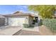 Charming single-story home featuring a two-car garage, tile roof, and well-maintained landscaping at 26 S Tiago Dr, Gilbert, AZ 85233